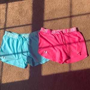 a pair of pink and blue under armour shorts